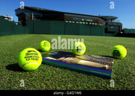 Tennis - 2011 Wimbledon Championships - Day Seven - The All England Lawn Tennis and Croquet Club. Detail of Wimbledon 125 Years official Slazenger tennis balls with official programme on a court before play on day seven Stock Photo