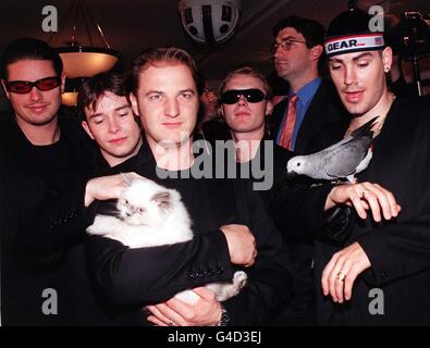 Irish boy band, Boyzone, befriend two living sale items in the Pet Department at Harrod's in Knightsbridge, London today (Wednesday) after officially opening the first day of the world famous department store's annual summer sale. Left to right: Keith Duffy, Stephen Gately, Michael Graham (holding cat), Ronan Keating and Shane Lynch (holding bird). See PA story CONSUMER Harrods. Photo by Fiona Hanson/PA Stock Photo