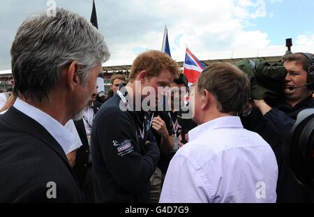 Prince Harry (centre) is interviewed by BBC Sport's Martin Brundle before the Santander British Grand Prix at Silverstone Circuit, Northampton. Stock Photo