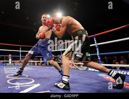 Kevin Mitchell (left) in action against John Murray during the WBO World Super-Featherweight Championship bout at the Liverpool Echo Arena, Liverpool. Stock Photo