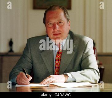 Secretary of State for Wales Ron Davies signs the first order under the Government of Wales Act 1998 (marking an historic step on the road to devolution for Wales), at the Welsh Office in Cardiff today (Tuesday). See PA story POLITICS Assembly. Photo Barry Batchelor/PA. Stock Photo