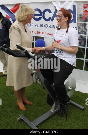 The Duchess of Cornwall with Steffanie McKenna, 26, after watching DecAid's Massed Pipes and Drums Parade from a dais in front of the Scottish Parliament in Holyrood Park, Edinburgh. Stock Photo