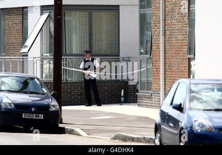 A general view of police at the scene on Banning Street in Greenwich, south-east London, where a man was shot in the head last night. Stock Photo