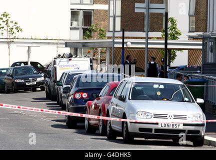 A general view of police at the scene on Banning Street in Greenwich, south-east London, where a man was shot in the head last night. The man, yet to be formally identified, later died from his injuries. Stock Photo