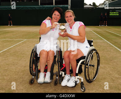 Netherlands' Esther Vergeer (right) and Sharon Walraven (left) celebrate with the trophy after defeating Netherlands' Jiske Griffioen and Aniek Van Koot in the final of the wheelchair ladies doubles on day thirteen of the 2011 Wimbledon Championships at the All England Lawn Tennis and Croquet Club, Wimbledon. Stock Photo