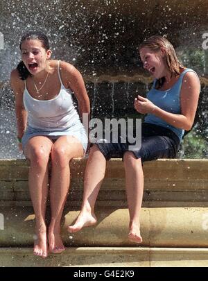 Vicky Woodcock (left) and Nicola Wilden from Essex splash around in the fountains in Trafalgar Square, in London, on one of the hottest days of the year as temperatures reached 25C in the capital. Picture by Stefan Rousseau./PA Stock Photo