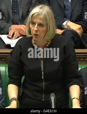 Home secretary Theresa May speaks in the House of Commons, London, after John Yates announced his resignation as one of Britain's top police officers following pessure over his handling of the phone hacking scandal. Stock Photo