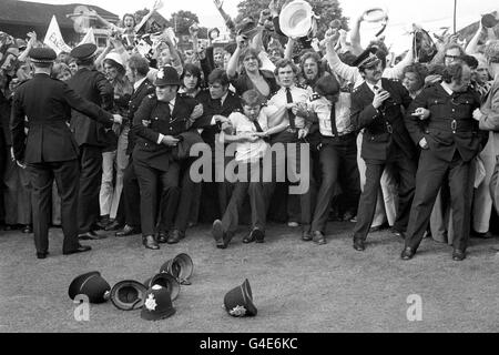 Cricket - Benson and Hedges Cup - Final - Middlesex v Leicestershire - Lord's. Police officers hold back joyous Leicestershire supporters on the pitch at Lord's after their team had beaten Middlesex by five wickets. Stock Photo