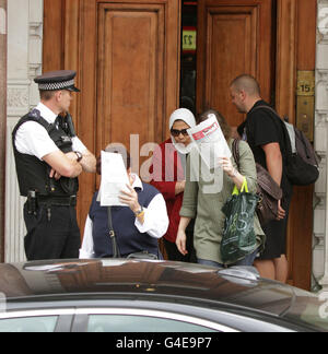 Unnamed women leave the Libyan Embassy in Knightsbridge, London, after Foreign Secretary William Hague announced that Britain is formally recognising the opposition National Transitional Council as the 'sole governmental authority' in Libya. Stock Photo