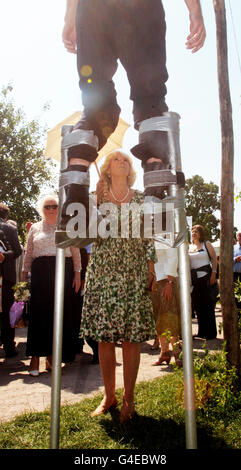 The Duchess of Cornwall looks at a stilt walker during a visit to the Hampton Court Palace Flower Show. Stock Photo