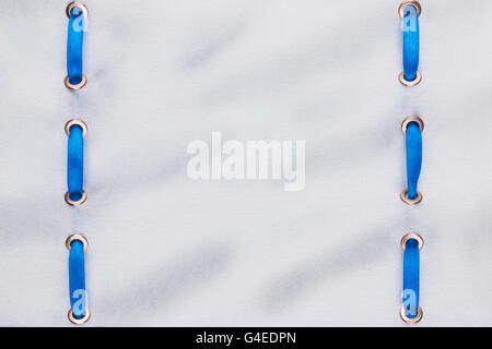 Fashionable beautiful background, blue satin ribbon inserted in white satin fabric, with space for your creativity Stock Photo