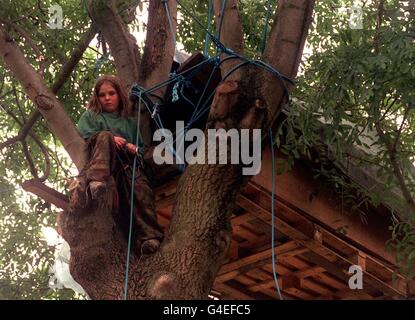 Matthew Williams looks down from his tree house at the Silver Birches site in Epsom, Surrey, today (Wednesday). Eleven-year-old Matthew, also known as General Survival, appeared with fellow eco-warriors at the High Court earlier in the day, when they won leave to appeal against Epsom and Ewell Borough Council's order to evict twenty residents of the park, before felling the trees to make way for a major road scheme. See PA story COURTS Warrior. Photo by Sean Dempsey/PA Stock Photo