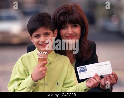 Krishan Radia, a six year old boy from Kenton, Middlesex celebrates with an ice cream as proud mother Neeta looks on today (Thursday). Krishan has become the youngest student to pass a GCSE examination, achieving grade C in Information systems at Ryde College in Northwood Middlesex. Photo by Michael Stephens/PA. Watch for PA story. Stock Photo