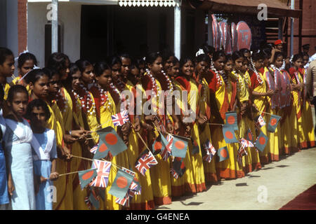 Flag waving children line up, waiting to welcome the Queen, on her visit to Bangladesh. Stock Photo