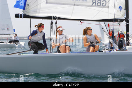 The British women's match racing team of Lucy MacGregor (left), Annie Lush and Kate MacGregor (right) get the Weymouth and Portland International Regatta underway during the London Olympic Games 2012 Test event and International Regatta in Weymouth. Stock Photo