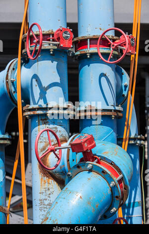 Large pipes, with hand wheels for valve control, drinking water pipes, on a construction site, conduct the drinking water, Stock Photo