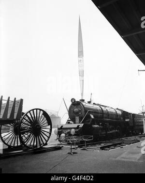 Finger of the future, the Skylon rears above it's earthbound attendant fountains and a giant locomotive in this Festival of Britain preview on the South Bank Exhibition site. The fountains, being fully tested for the first time, flank the base of the 290ft high Skylon. The 173 ton locomotive was built in Glasgow for the Indian Government Railways and is being shown at the Exhibition before going overseas. Stock Photo