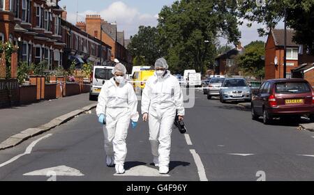 Scenes of crime officers pictured on Shrewsbury Street, Manchester after a shopkeeper was arrested on suspicion of attempted murder after a man trying to rob his store was stabbed to death. Stock Photo