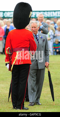 The Prince of Wales shakes hands with a soldier during a visit to the Sandringham Flower Show in Sandringham, Norfolk. Stock Photo