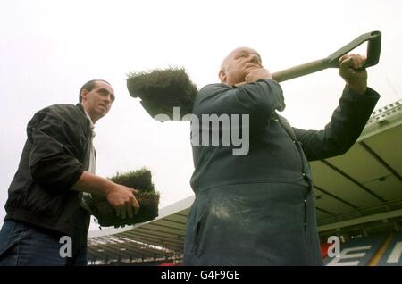 Norrie Henderson retired Head Groundsman (right) and new Head Groundsman Willie Makey start taking up the famous Hampden turf from Scotland's national football stadium. The turf will be given away to fans to make way for a new pitch. See PA story SPORT pitch. Photo by David Cheskin/PA Stock Photo