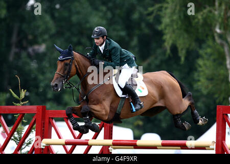 Ireland's Denis Lynch riding Nabab's Son in the Nation Cup at the Longines Royal Hickstead International Horse Show at The All England Jumping Course, Hickstead. Stock Photo