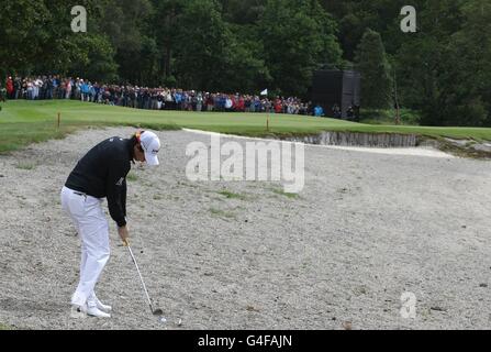 Northern Ireland's Rory McIlroy hits his way out of a bunker on the 1st Green Stock Photo