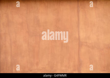 close up detail of rustic textured terracotta coloured stucco wall background Stock Photo