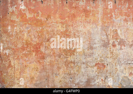 Old weathered and worn stucco wall in ochre and earth colours background Stock Photo
