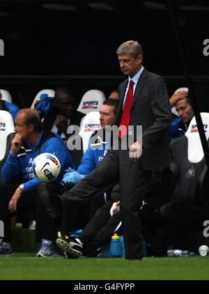 Arsenal manager Arsene Wenger kicks the ball during the Premier League ...