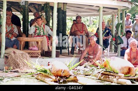 The Duke of York sit's in the shade of a Fale (open sided tin hut), as a lunch of 2 roasted pig's were laid before him. The Duke later took part in a traditional dance ceremony in Apia, the capital of Samoa. The Duke was dressed in grass skirt, and with a mat over his legs as he was made a Samoan chief today (thursday). PHOTO BY JOHN STILLWELL/PA. Stock Photo
