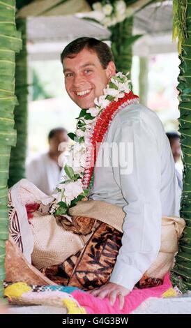 The Duke of York sits in the shade of a Fale (open sided tin hut), before taking part in a traditional dance ceremony in Apia, the capital of Samoa. The Duke was dressed in grass skirt, and with a mat over his legs as he was made a Samoan chief today (Thursday). PHOTO BY JOHN STILLWELL/PA. Stock Photo
