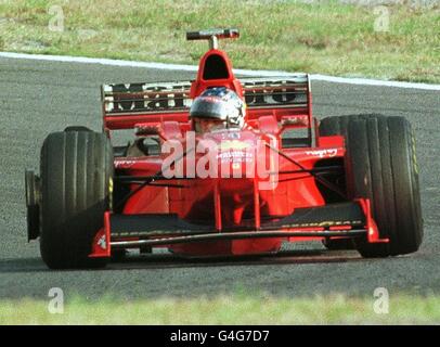 German F1 driver Michael Schumacher of Ferrari looks back as his rear-right tire bursts in the 32nd lap of the Formula One Japanese Grand Prix in Suzuka 01 November. Competing four-points behind Mika Hakkinen of Finland, Schumacher retired from the race. PA NEWS PHOTO Stock Photo