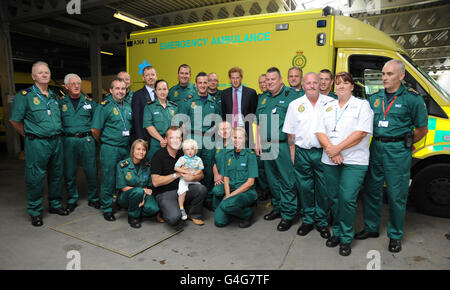 Prince Harry has his photo taken with ambulance staff at Salford Ambulance headquarters in Manchester. The Prince met with ambulance staff who worked during the riots in Salford last week. Stock Photo