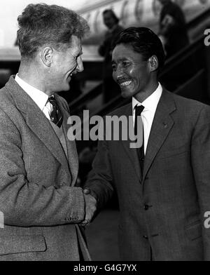 Sherpa Tensing Norgay, joint conqueror with Sir Edmund Hillary of the Everest peak, is seen being welcomed by Brigadier Sir John Hunt, who led the successful 1953 expedition, on his arrival at London airport. * 7/11/98 : Sir John Hunt, who led the successful 1953 expedition, died at his Henley, Oxfordshire, aged 88. Stock Photo