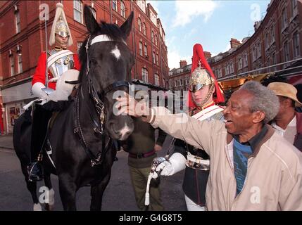 Members of the Household Cavalry Mounted Regiment visit Electric Avenue in Brixton, London today (Tuesday). The men and the horses which are normally seen on guard at Horse Guards, Whitehall are trying to foster links between the regiment and the London Boroughs. Photo by Toby Melville/PA. Stock Photo