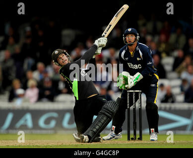 Surrey's Tom Maynard in action batting as Durham wicketkeeper Phil Mustard looks on Stock Photo