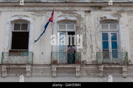Cuban man standing on his balcony Stock Photo