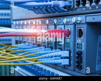 Fiber network switch with some yellow optical network cables Stock Photo
