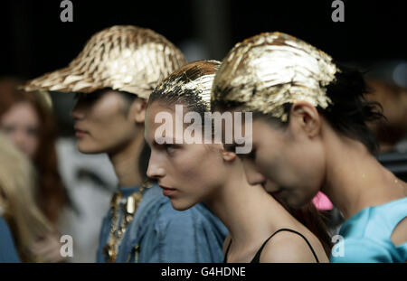 Models backstage during the Unique spring/summer 2012 show at the Topshop Venue at the Old Eurostar Station in Waterloo, central London, as part of London Fashion Week. Stock Photo