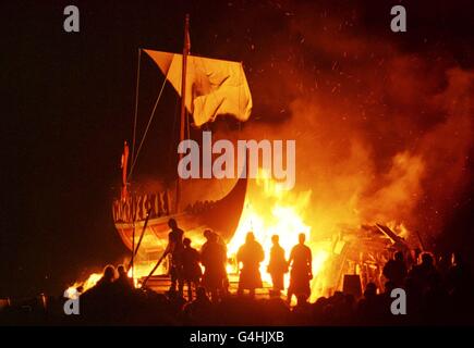 A viking long boat is burned on Calton Hill, Edinburgh, at the end of a torchlight procession along Princes Street at the beginning of Edinburgh`s fire festival to mark the start of the Hogmanay celebrations. Stock Photo