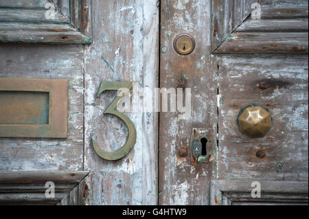 Old Door with letterbox, keyhole and number 3 Stock Photo