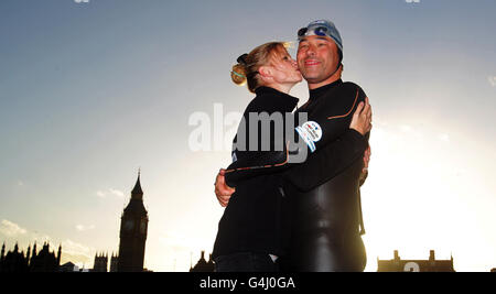 David Walliams is kissed by his wife Lara Stone after he completed his 140-mile charity swim along the River Thames in Westminster, London. Stock Photo