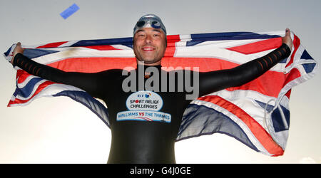 David Walliams celebrates as he completes his 140-mile charity swim along the River Thames in Westminster, London. Stock Photo