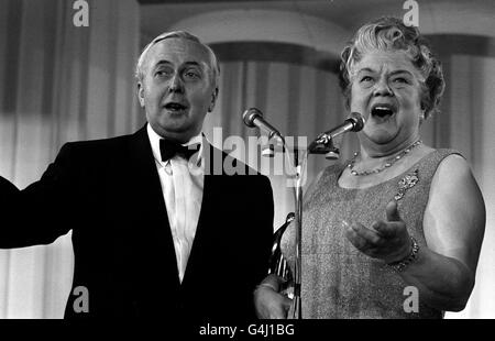 PA NEWS PHOTO 14/5/70 HAROLD WILSON JOINS ACTRESS VIOLET CARSON - ENA SHARPLES OF THE TELEVISION SOAP 'CORONATION STREET' IN A DUET AT THE ROYAL LANCASTER HOTEL IN LONDON. 'ALIVE, ALIVE-O!' THEY SING. THE PRIME MINISTER WAS PRESENTING THE SUN TV AWARDS. Stock Photo