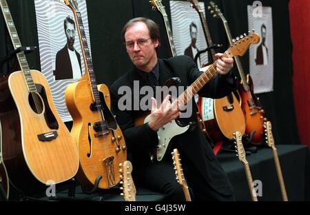 Andy Fairweather Lowe of Amen Corner, with some of Eric Clapton's guitars which are on view at Christie's, London ahead of the New York auction of his guitars for charity. Stock Photo