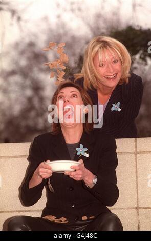 Carol Vorderman TV Presenter sitting on grass lawn holding paperback ...