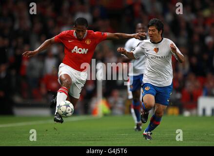 Basle's Joo-Ho Park (right) and Manchester United's Antonio Valencia (left) battle for the ball Stock Photo