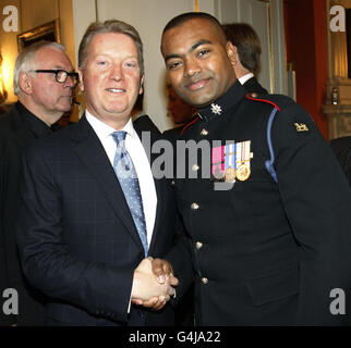 Frank Warren shakes the hand of Lance Corporal Johnson Beharry VC, during a Tickets for Troops reception, hosted by Samantha Cameron, the wife of Prime Minister David Cameron, at 10 Downing Street, London, ahead of a match between the UK combined services boxing team & the US Marine Corps (USMC) boxing team. Stock Photo