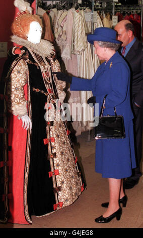 Her Majesty the Queen visiting costume and production department Angels and Berman in Camden, London where she was shown costumes from the film 'Shakespeare in Love' today (Thursday). Picture shows Her Majesty the Queen inspecting a costume for Queen Elizabeth 1. SUN ROTA PICTURE BY PAUL EDWARDS Stock Photo