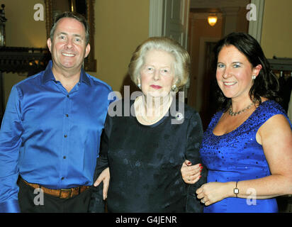 Secretary of State for Defence Dr Liam Fox (left) and his wife Jesme (right) former Prime Minister Baroness Thatcher at his 50th birthday party held at Admiralty House in Whitehall, central London. Stock Photo
